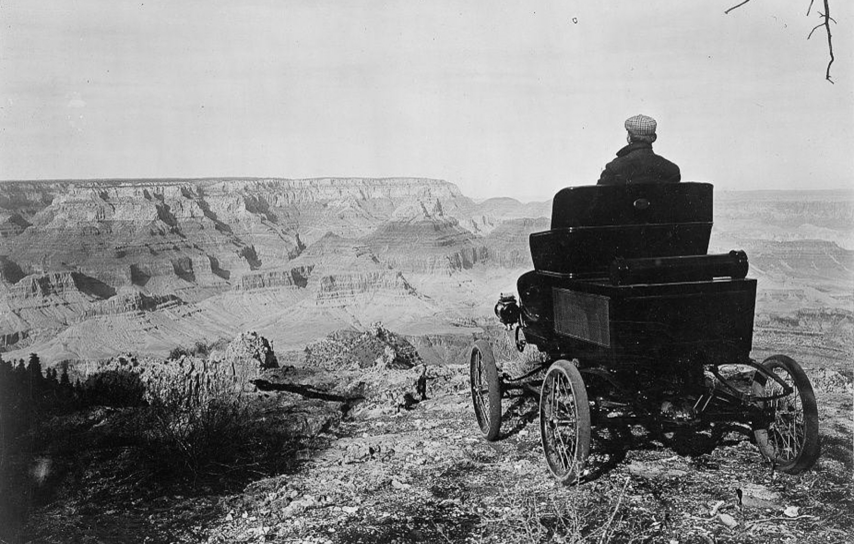 A member of the pioneer automobile party in a Toledo car at the rim of the Grand Canyon, Grand View Park, Arizona,1902
