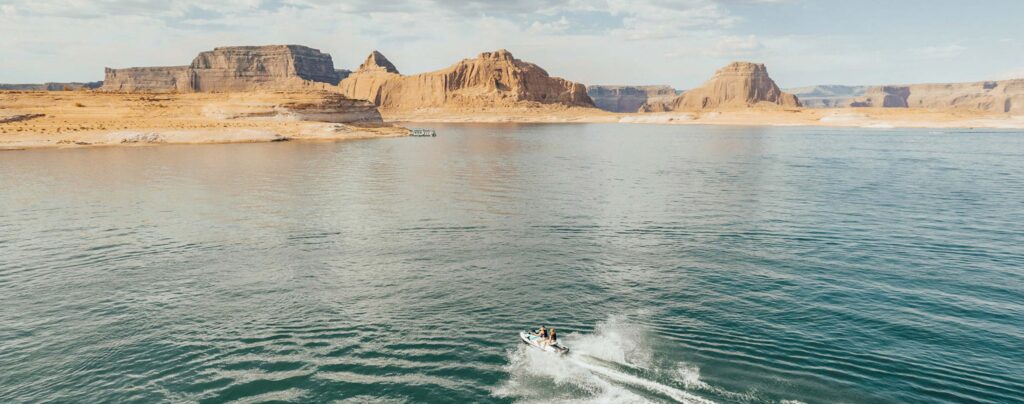 Friends jet ski together across Lake Powell.