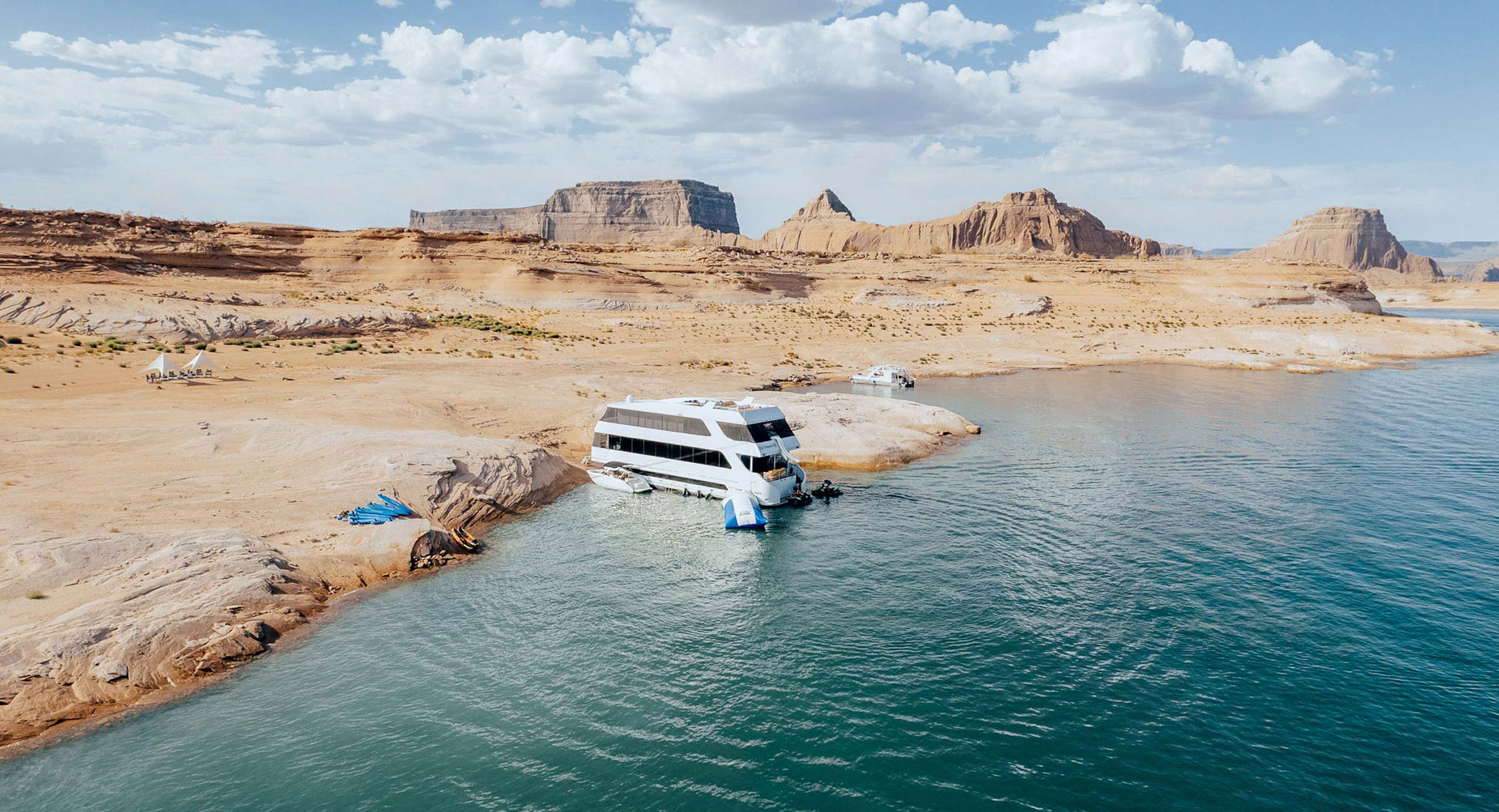 A luxury houseboat is docked on the banks of Lake Powell in Arizona.