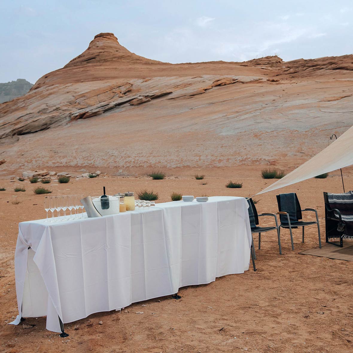 A sunset feast with champagne is set up on the shores of Lake Powell.