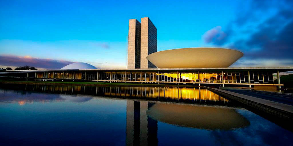 The National Congress of Brazil in Brasilia, featuring the Oscar Niemeyer domes and twin towers at sunset.