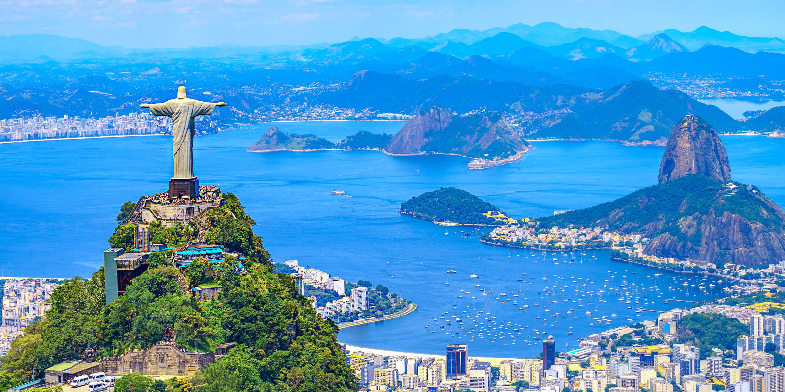 Panoramic view of Rio de Janeiro, Brazil, with the Christ the Redeemer statue overlooking the bays and city.