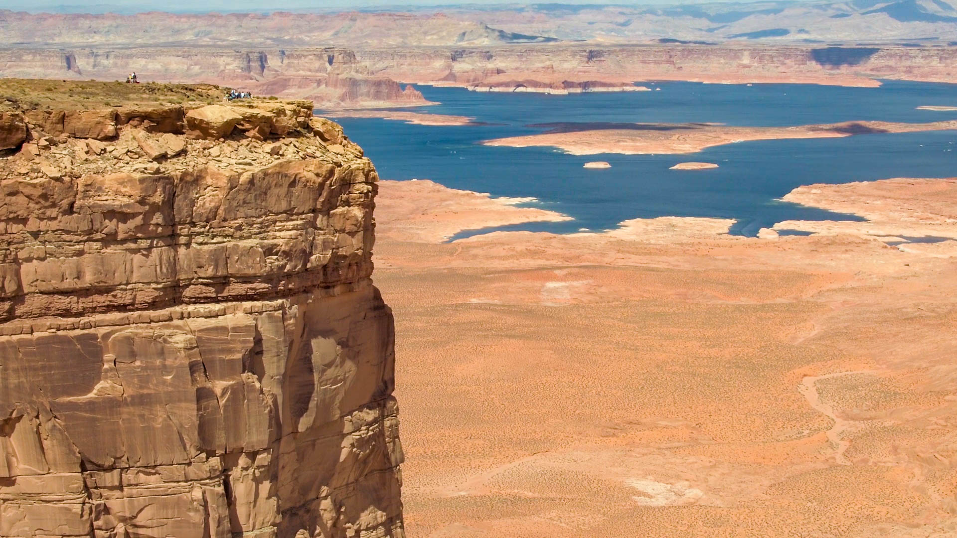 A family sits atop Tower Butte overlooking Lake Powell during a celebratory brunch.
