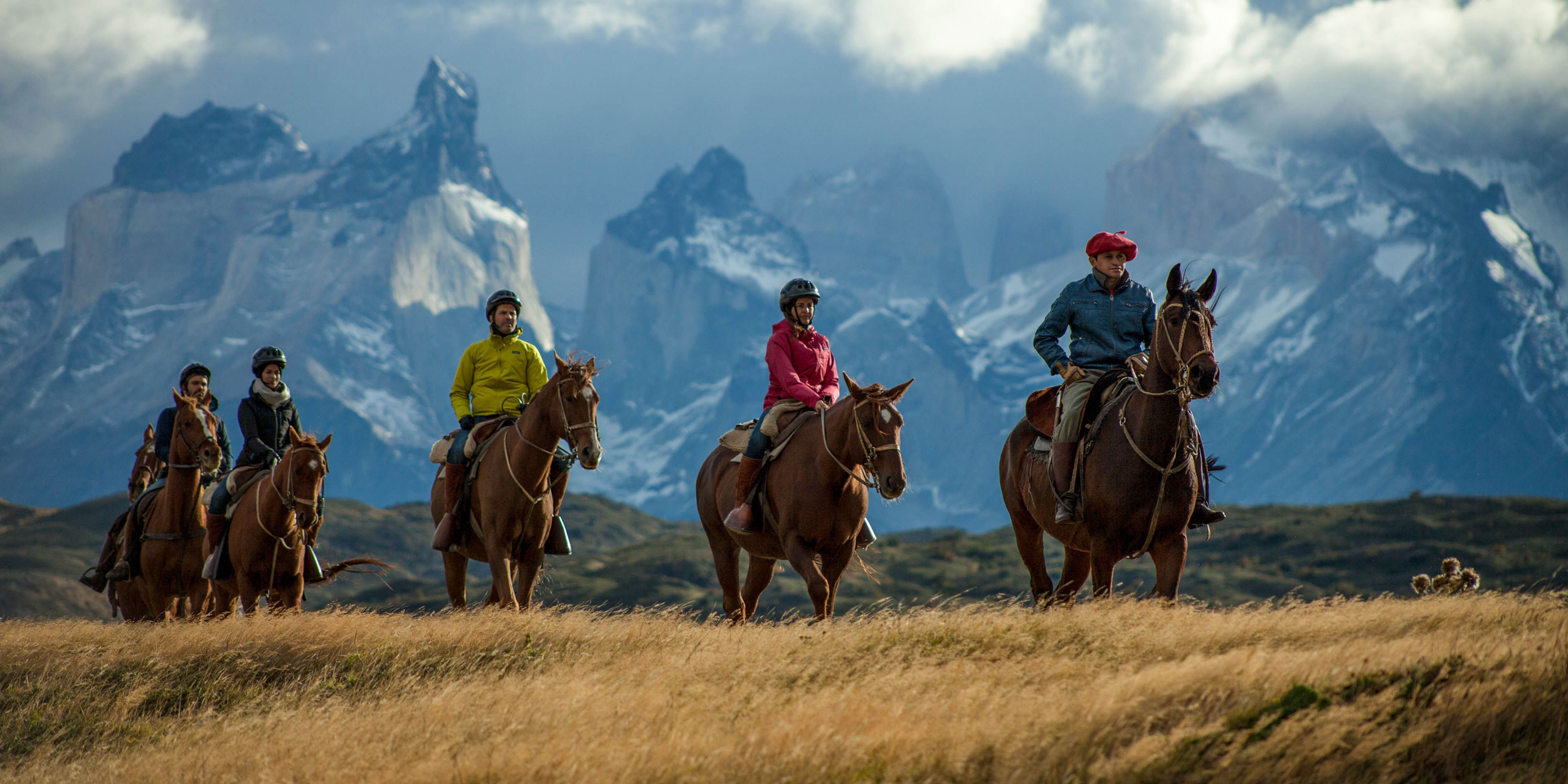 A local gaucho guides friends on horseback through the countryside in Patagonia.