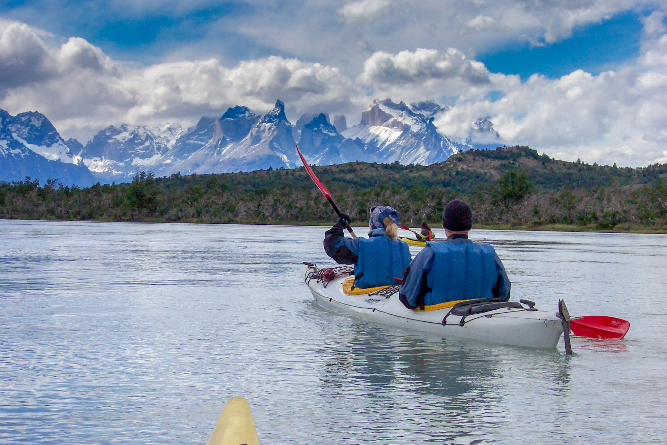 A couple kayaks in Patagonia with Torres del Paine in the background.