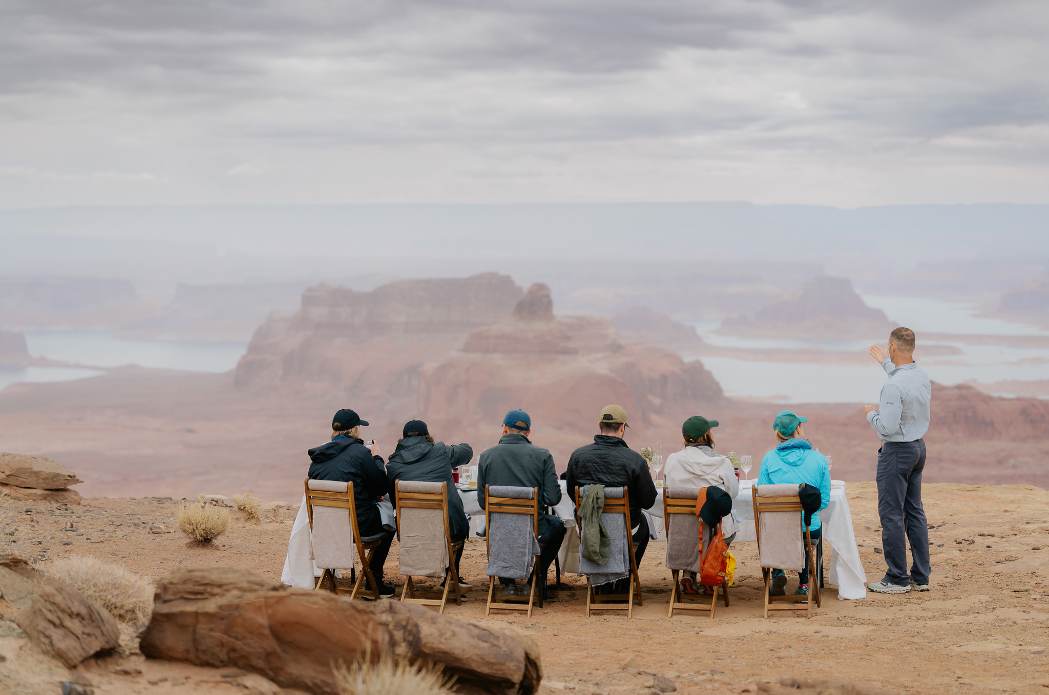 Friends enjoy lunch together atop Tower Butte overlooking Lake Powell.