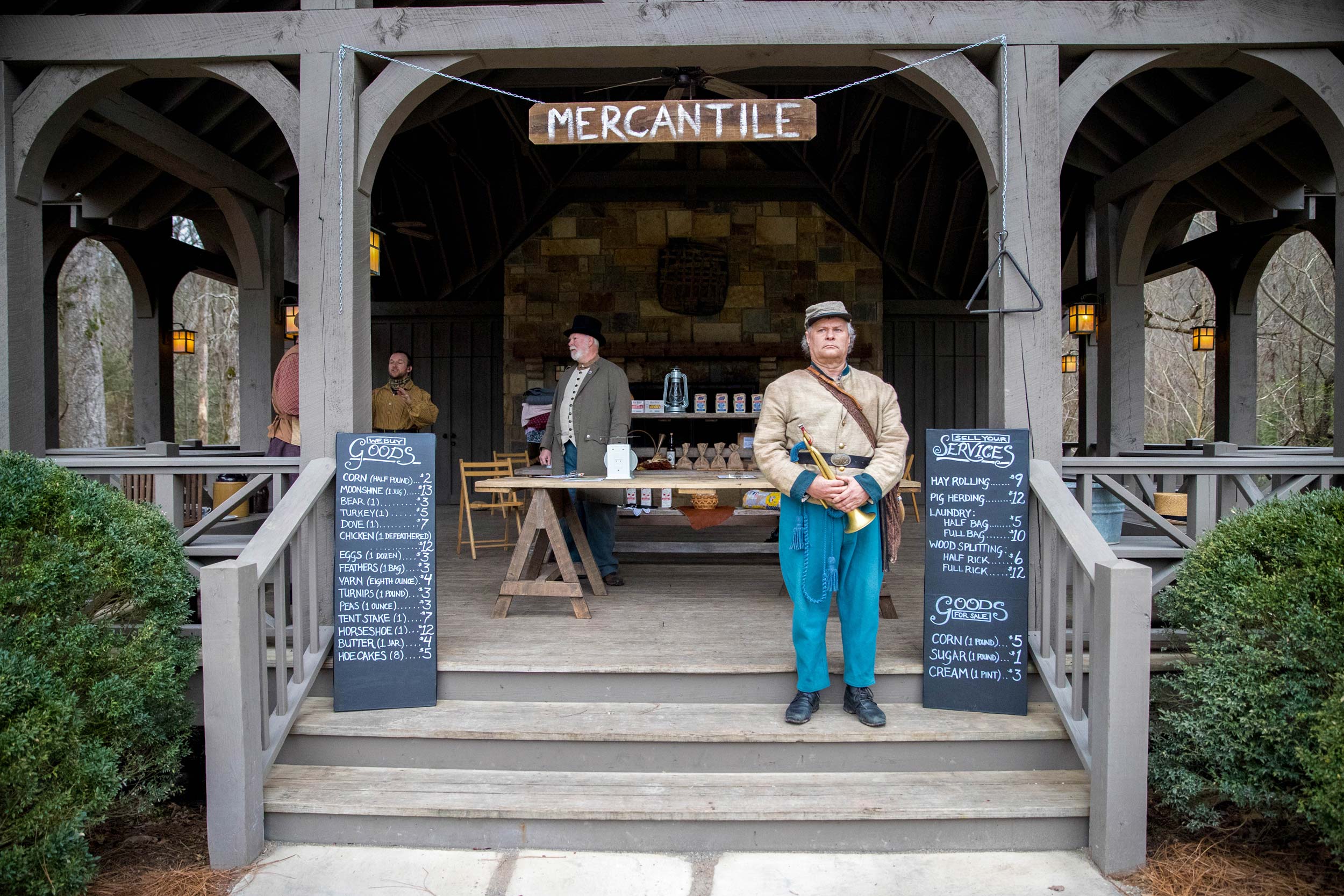 - EXP Journeys Characters in colonial costumes stand by a mercantile station at an immersive event in Tennessee.