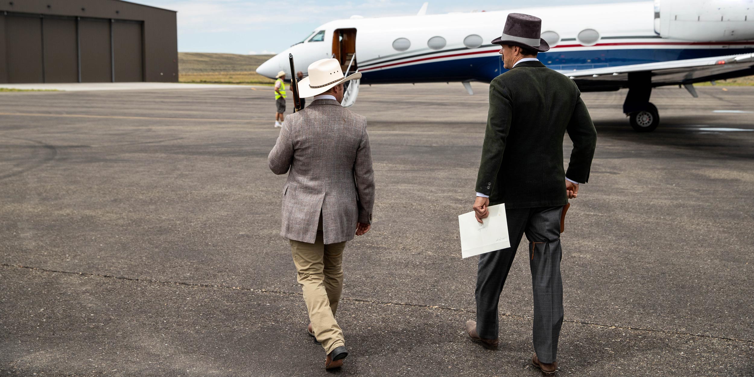 - EXP Journeys Old west characters walk across the tarmac to greet guests embarking from their private jet.