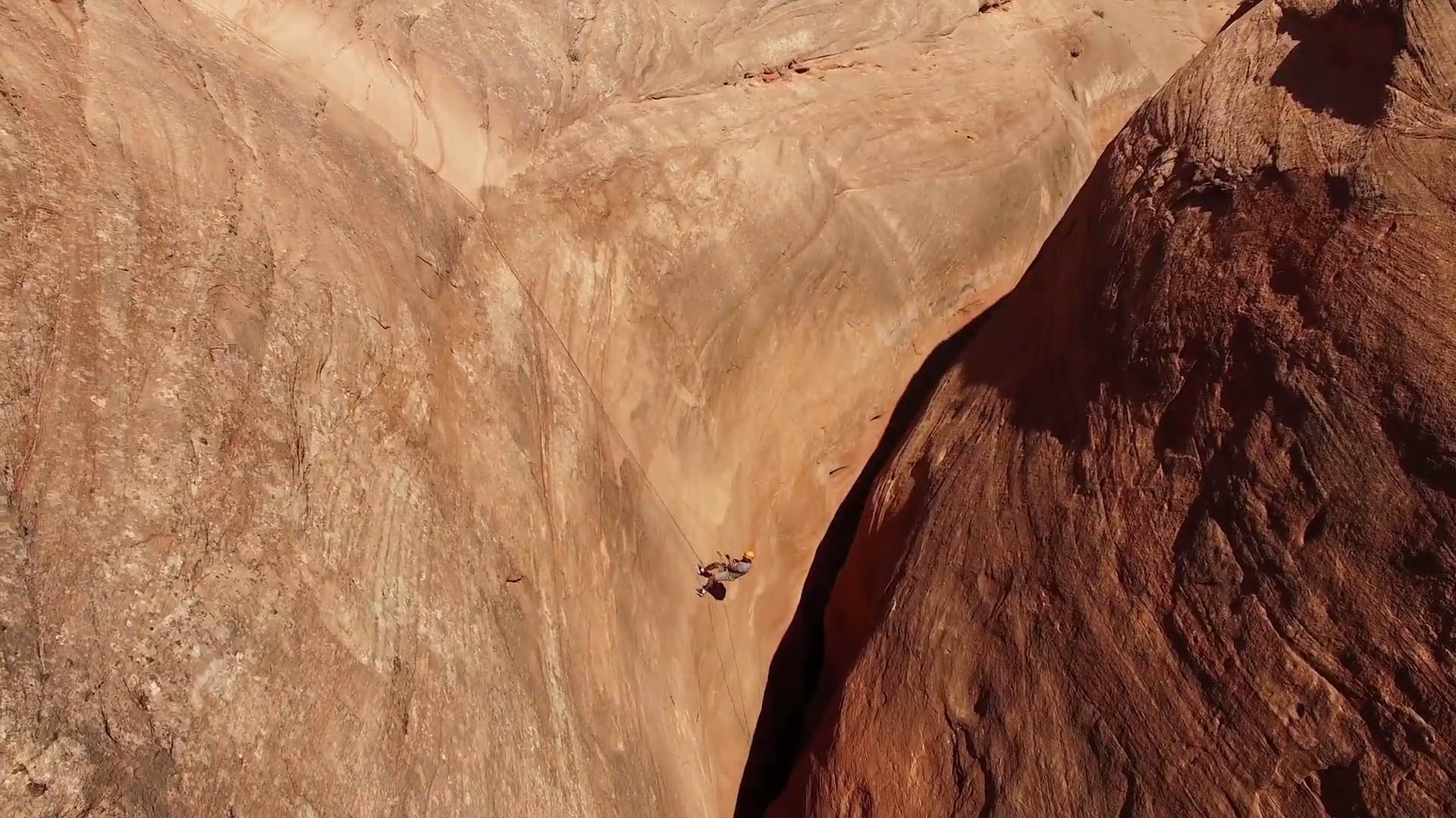 A climber rappels into a slot canyon during a private experience.