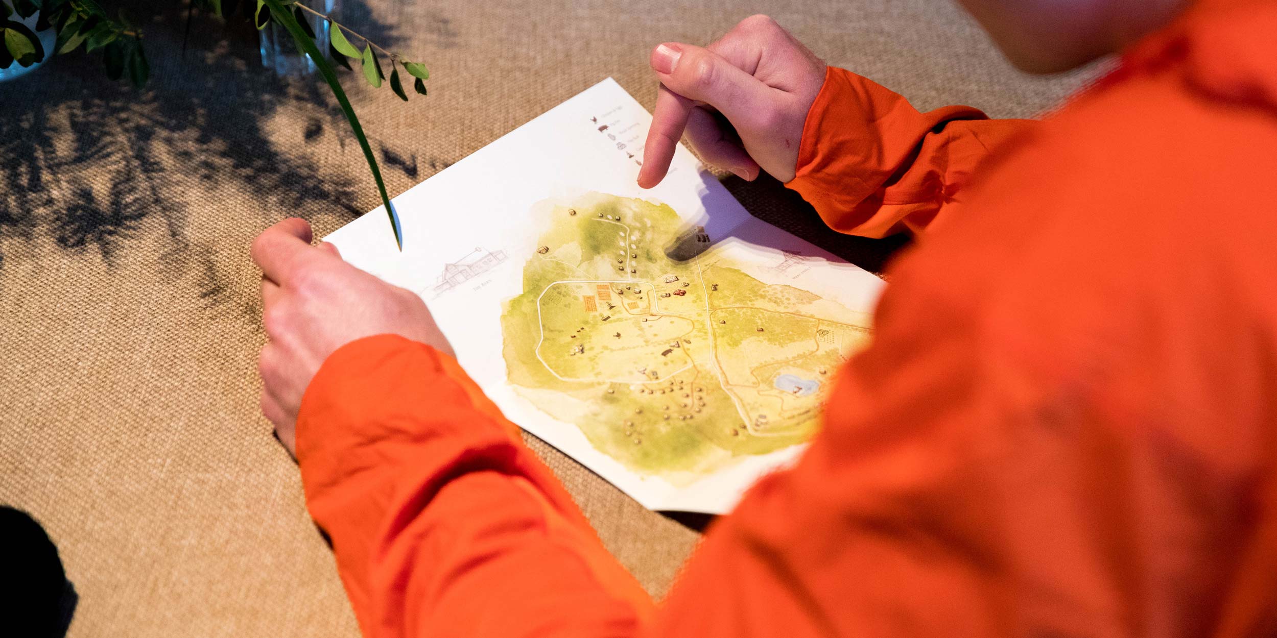 A person looks at a map with clues for a team challenge.