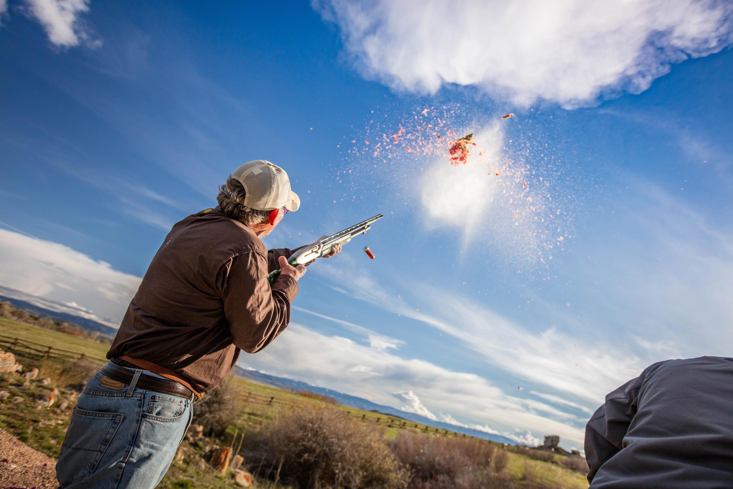 A man shoots a target at a ranch in the Wild West.