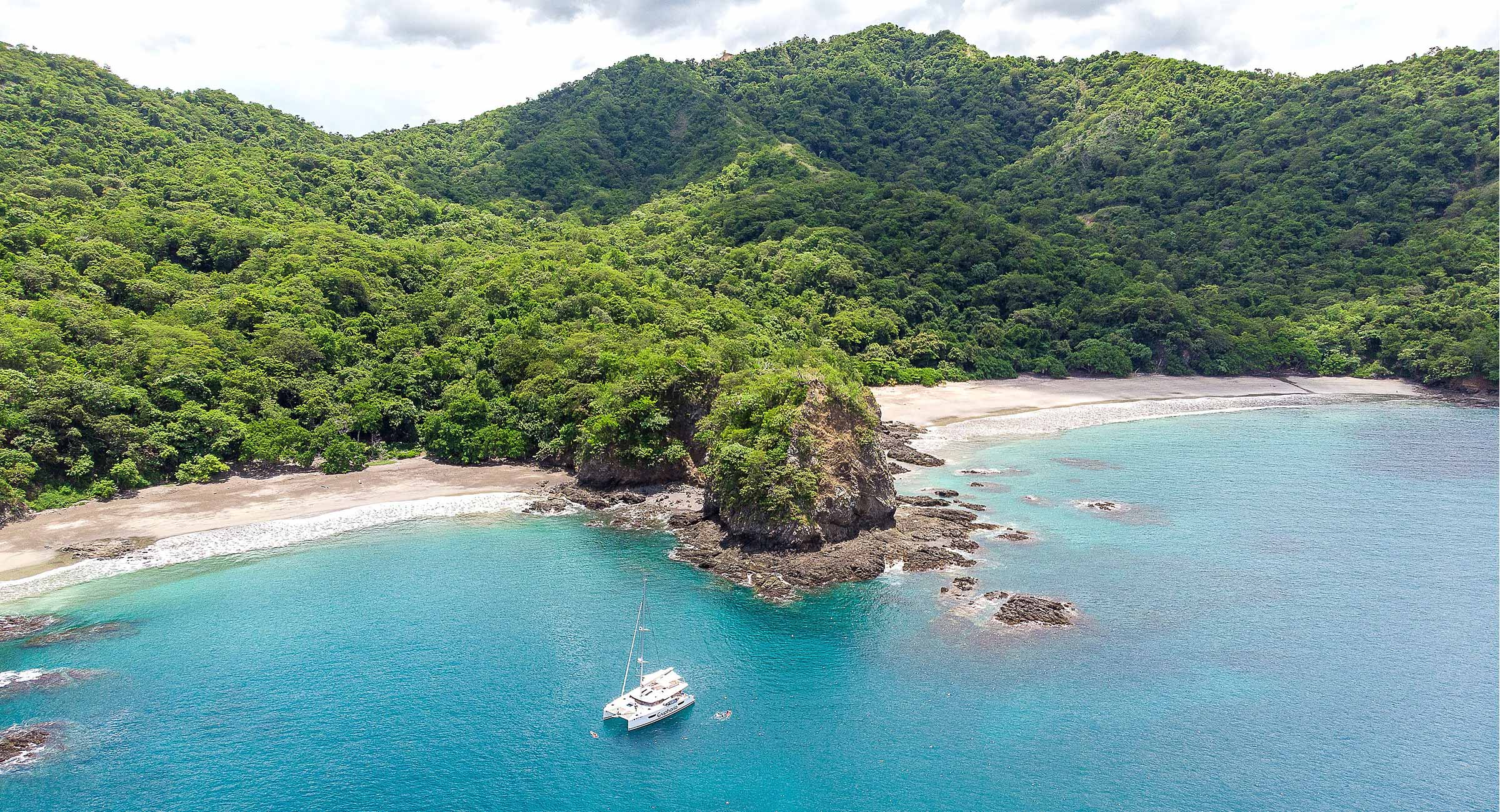 costa-rica-fishing-boat A luxury catamaran anchored in a turquoise bay along the Costa Rica coast, perfect for a private day on the water.
