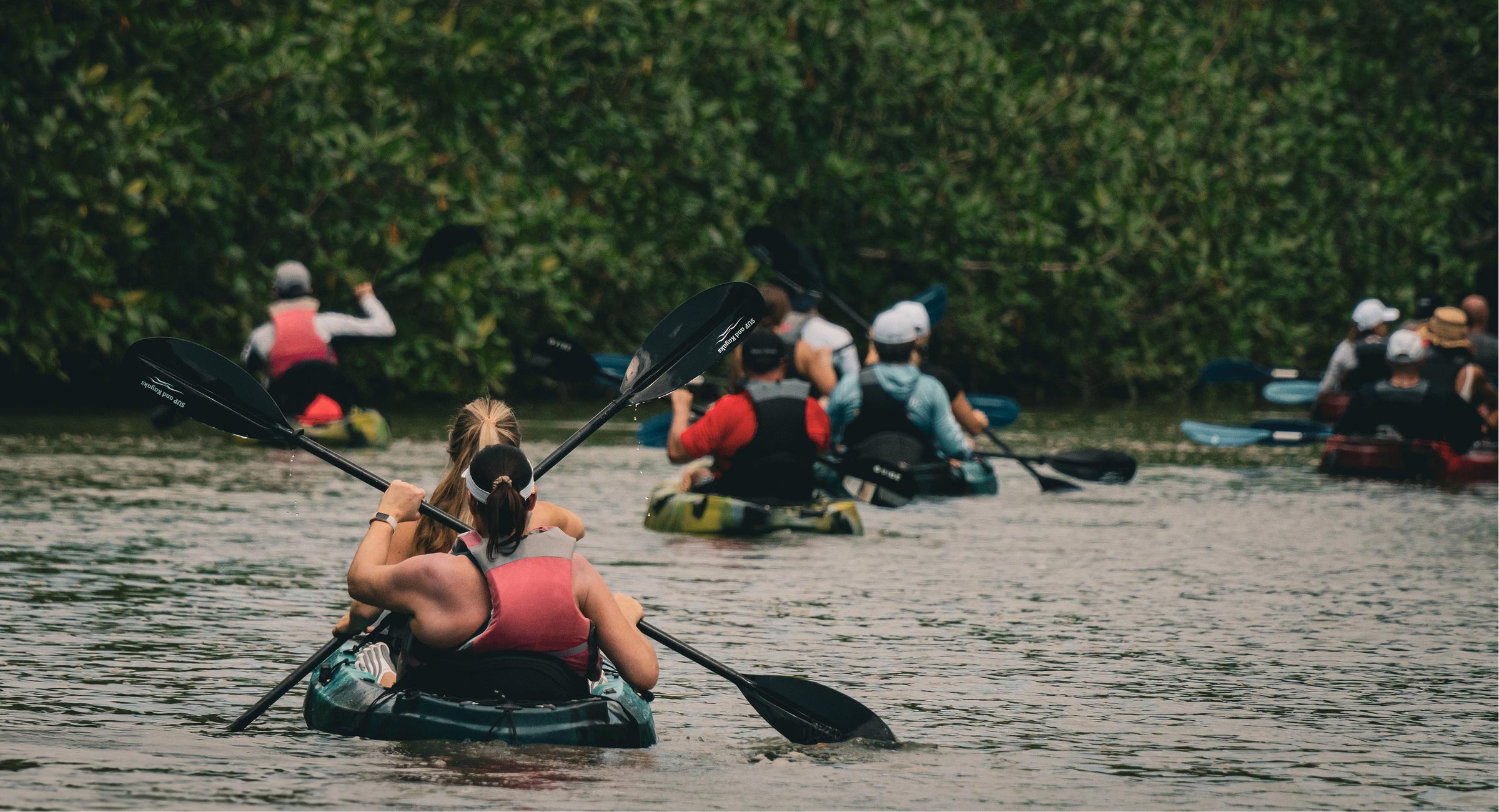 costa-rica-kayak-group Travelers enjoying a guided kayaking excursion through calm tropical waters in Costa Rica.