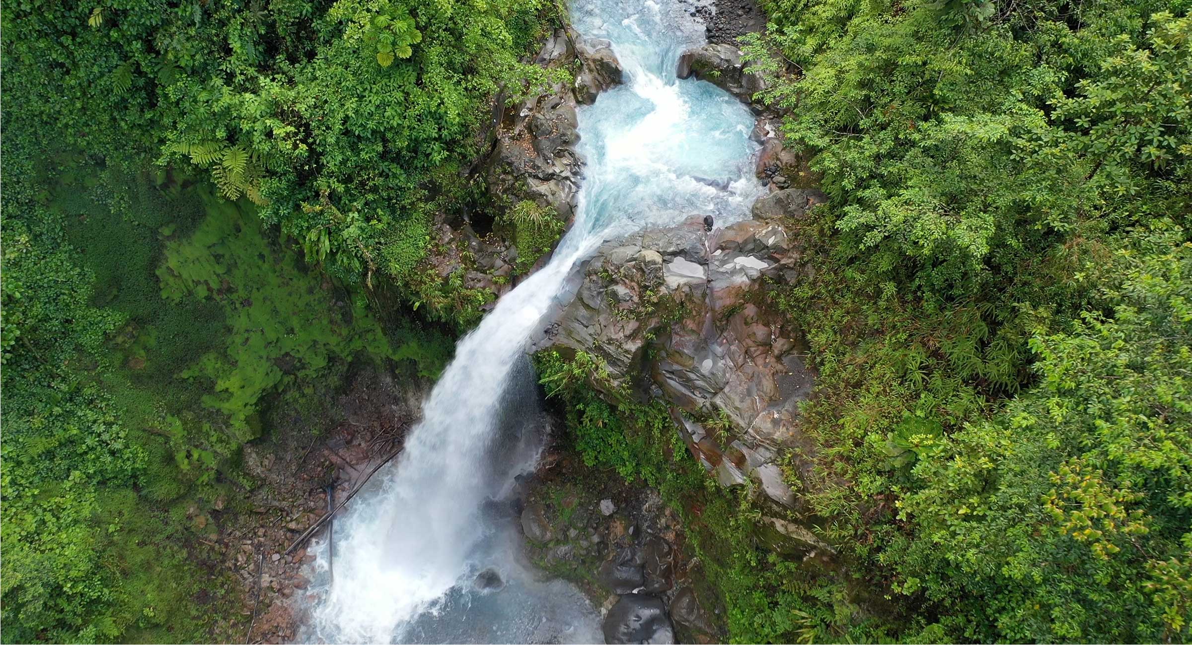 costa-rica-waterfalljpg Aerial view of a stunning turquoise waterfall hidden deep within the lush Costa Rica jungle.